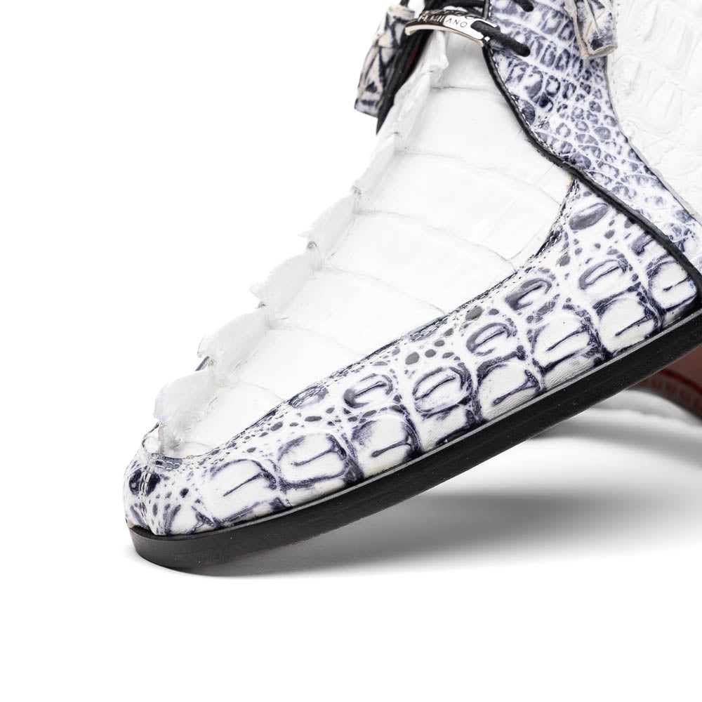 The Marco Di Milano Caribe White / Newspaper Derby shoes feature white and black crocodile-patterned leather, one upright and one on its side to showcase a brown leather sole with red stitching—distinctive, exotic hand-painted footwear.