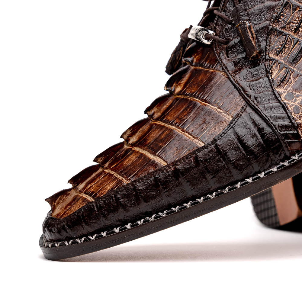 The Marco Di Milano Caribe Rustic Orix/Brown features luxury derby shoes crafted from genuine hornback caiman crocodile leather, with one upright and the other on its side showcasing a tan sole, visible stitching, and hand-painted finishes.