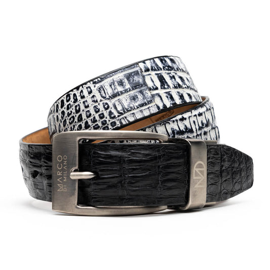 The Caribe Belt Black / Newspaper by Marco Di Milano features a black and white crocodile pattern with a silver buckle, engraved logo, and offers a refined style evocative of exotic leather craftsmanship.