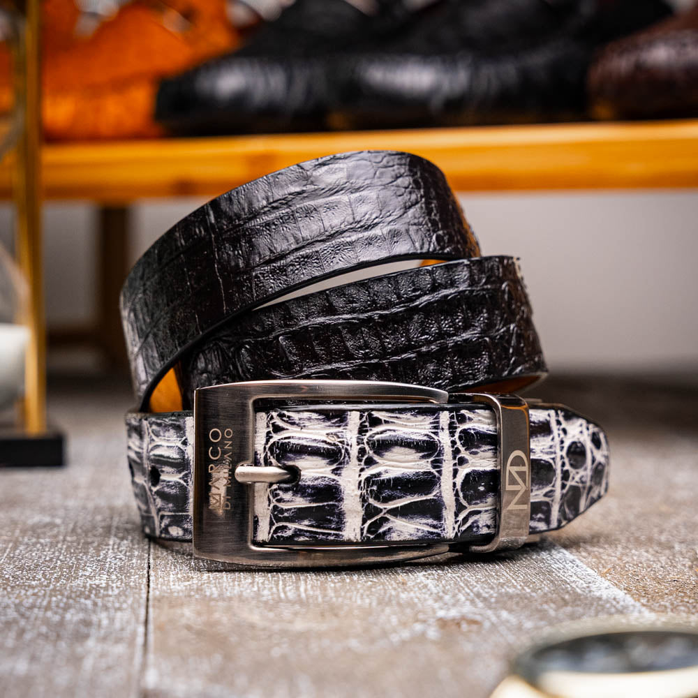 The Caribe Belt Newspaper / Black by Marco Di Milano features rolled black leather, a newspaper-textured white and black tip, and a silver engraved buckle—an elegant statement of luxury exotic belts.