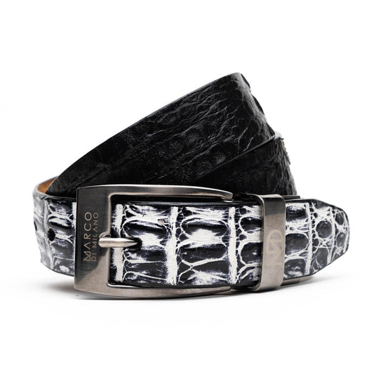 The Caribe Belt Newspaper / Black by Marco Di Milano features rolled black leather, a newspaper-textured white and black tip, and a silver engraved buckle—an elegant statement of luxury exotic belts.