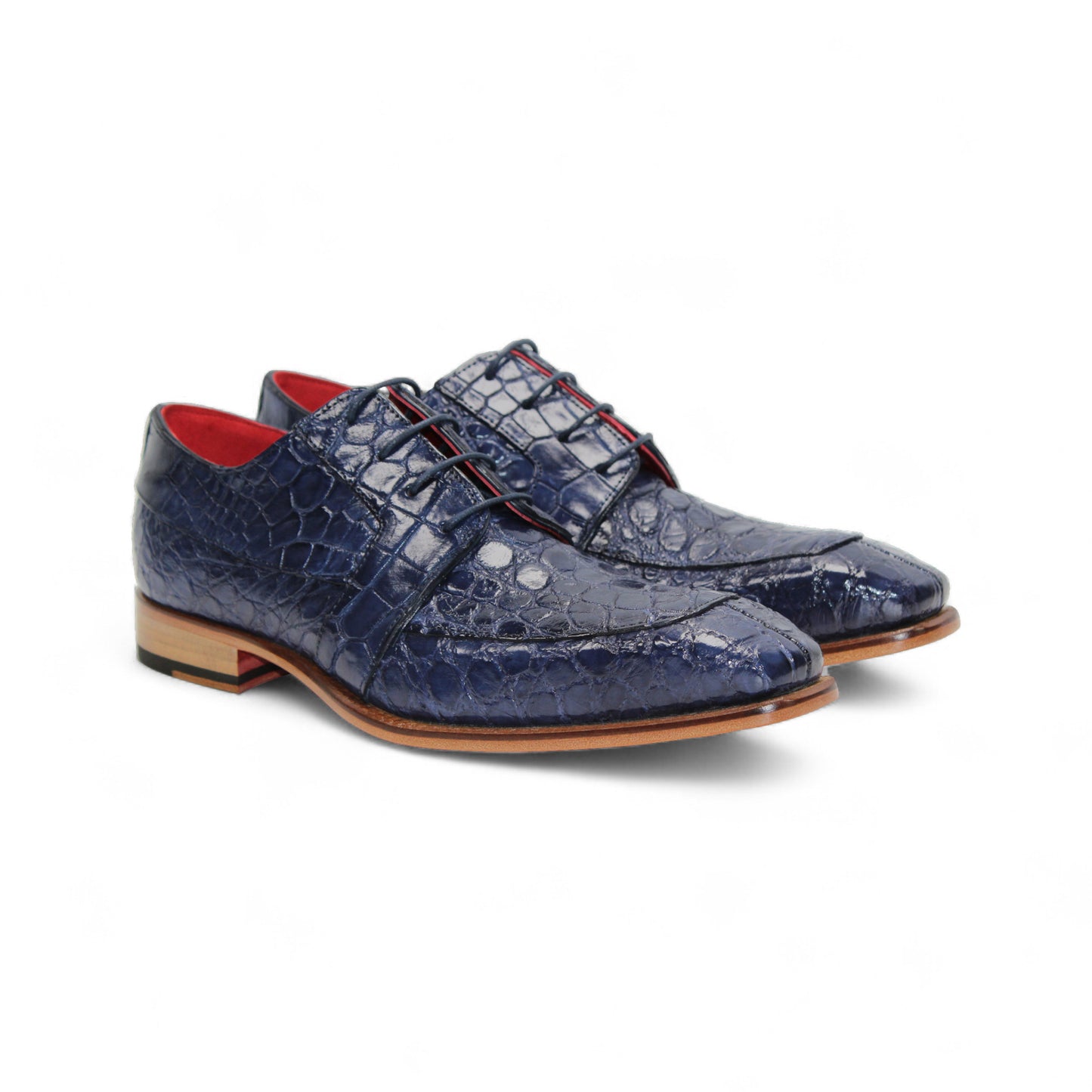The Fennix Charles Ocean Blue by Fennix of Italy is a navy crocodile-pattern leather dress shoe with a pointed toe, brown sole, and red interior accents, highlighting Italian craftsmanship in a profile view on a white background.
