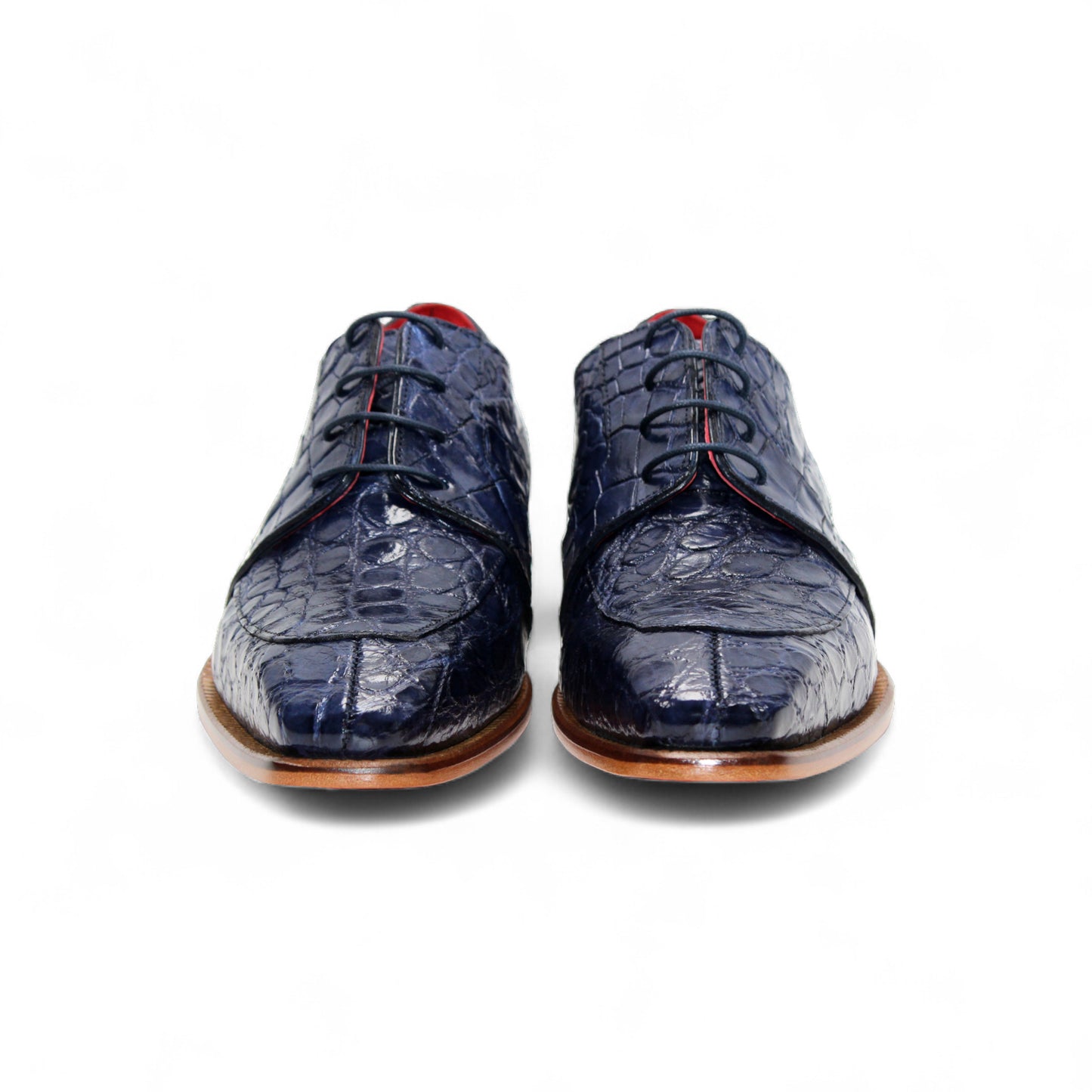 The Fennix Charles Ocean Blue by Fennix of Italy is a navy crocodile-pattern leather dress shoe with a pointed toe, brown sole, and red interior accents, highlighting Italian craftsmanship in a profile view on a white background.