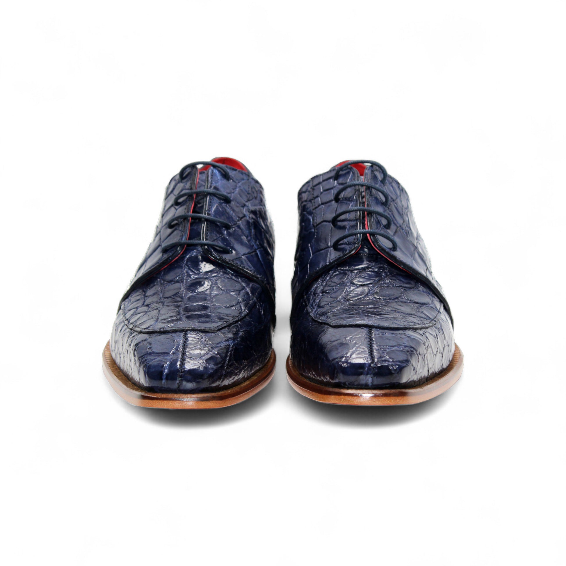 The Fennix Charles Ocean Blue by Fennix of Italy is a navy crocodile-pattern leather dress shoe with a pointed toe, brown sole, and red interior accents, highlighting Italian craftsmanship in a profile view on a white background.