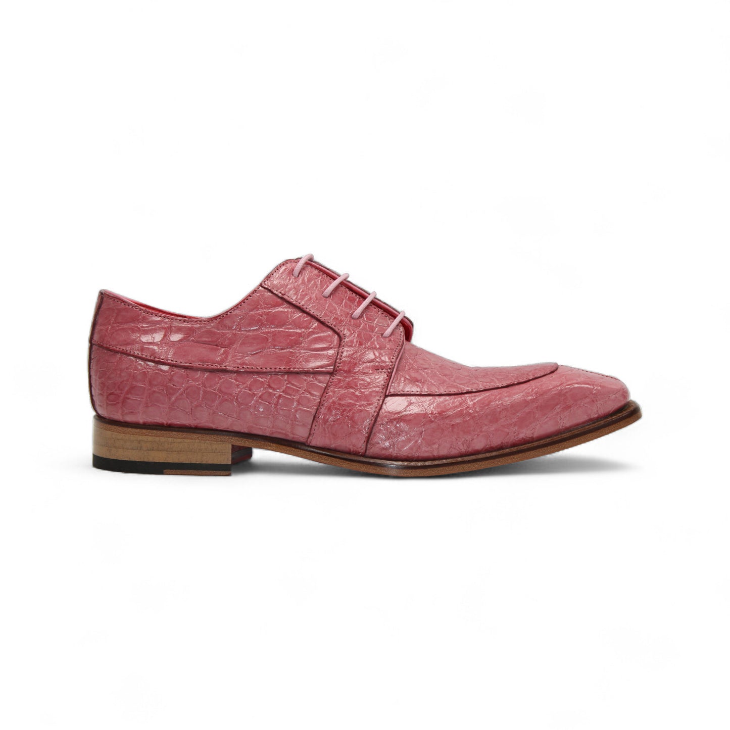 The Fennix of Italy "Fennix Charles Antique Pink" dress shoe features a pink crocodile-patterned leather upper, lace closure, and a wooden sole, showcased in profile on a white background.