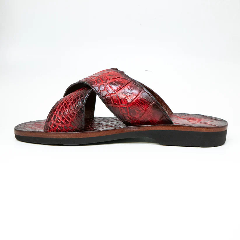 The Elios Black Cherry by Marco Di Milano is a red, textured leather slide sandal featuring crisscross straps and a flat black sole, displayed against a plain white background.