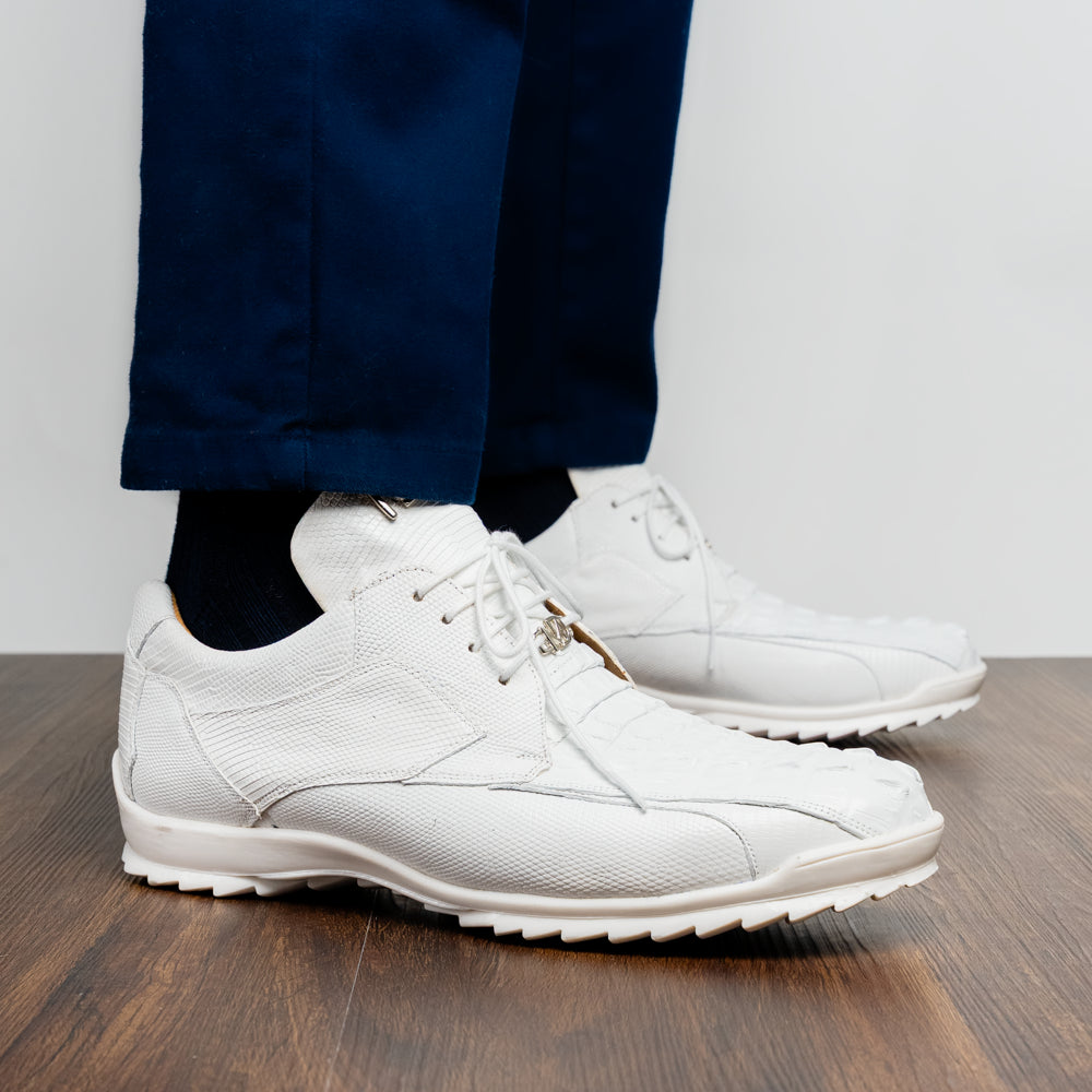 The Crater White sneakers by Marco Di Milano feature white textured leather lizard skin and a lace-up closure; one shoe stands upright while the other is tilted to reveal the sole.