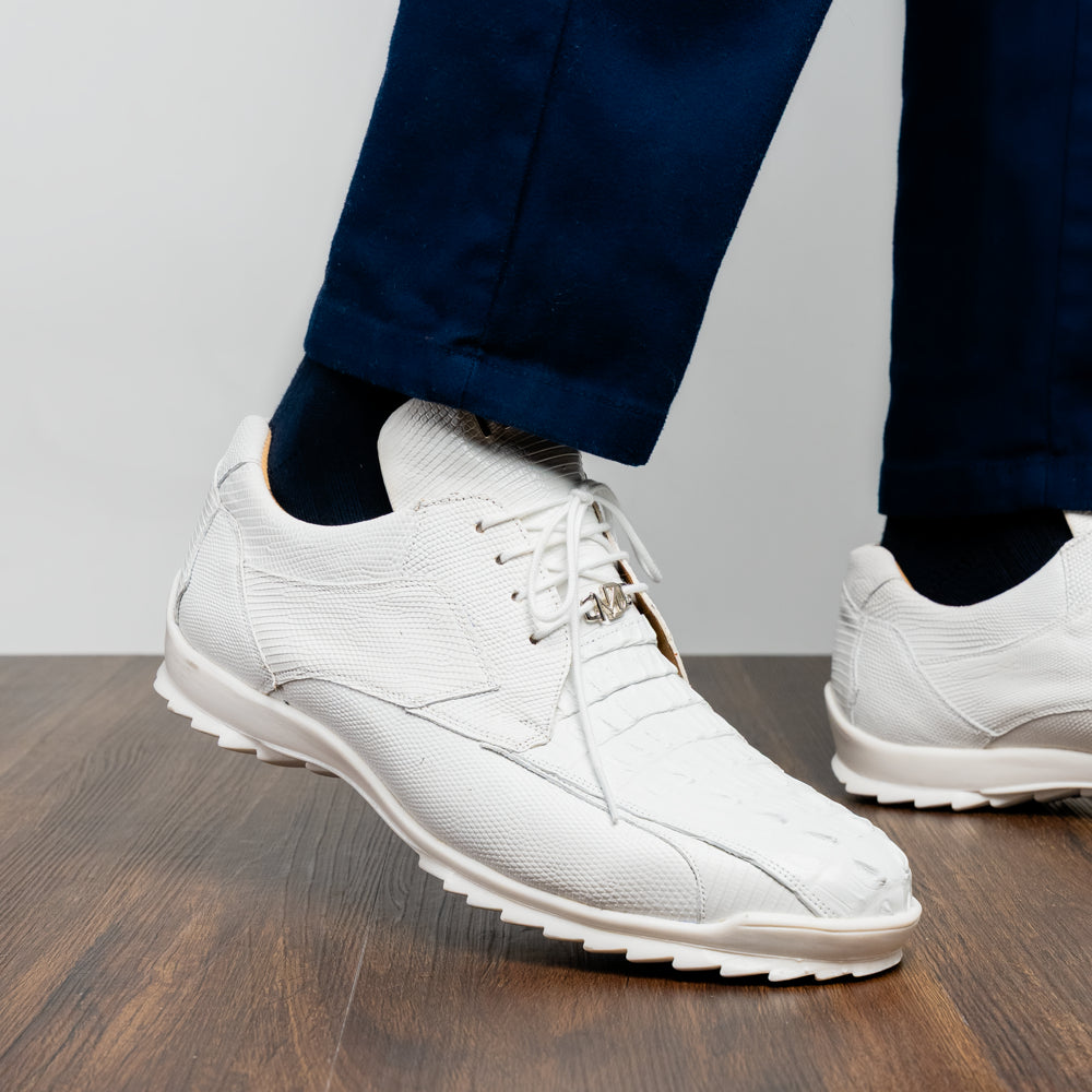 The Crater White sneakers by Marco Di Milano feature white textured leather lizard skin and a lace-up closure; one shoe stands upright while the other is tilted to reveal the sole.