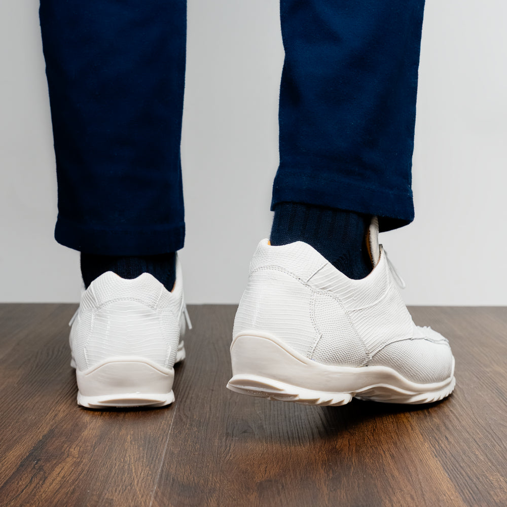 The Crater White sneakers by Marco Di Milano feature white textured leather lizard skin and a lace-up closure; one shoe stands upright while the other is tilted to reveal the sole.