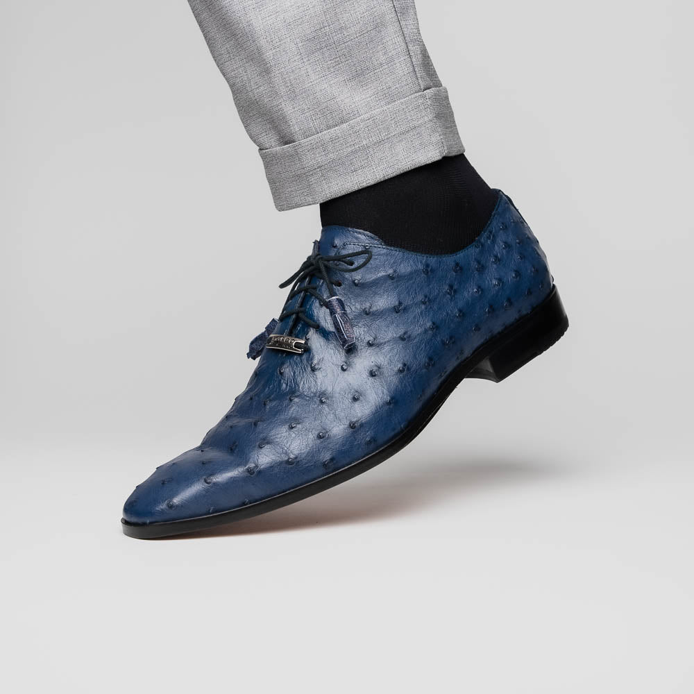 The Criss Navy by Marco Di Milano: a pair of genuine ostrich dress shoes with blue leather, black laces, red inner lining, and brown soles—one upright, one on its side—showcasing luxury men’s footwear.
