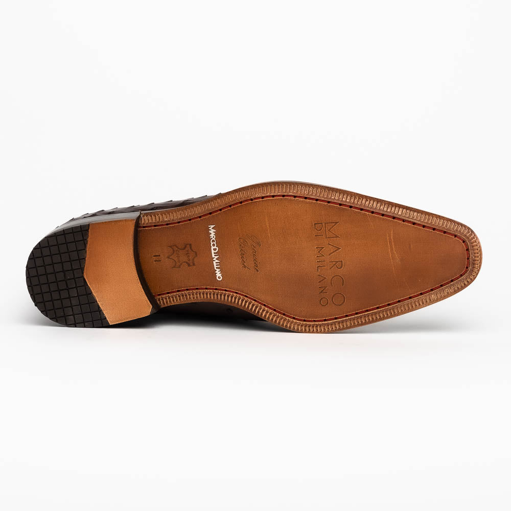 The Criss Brown by Marco Di Milano is a pair of luxury dress oxfords in dark brown genuine ostrich quill leather with decorative laces and a leather sole, shown with one shoe elegantly displayed on its side atop the other.