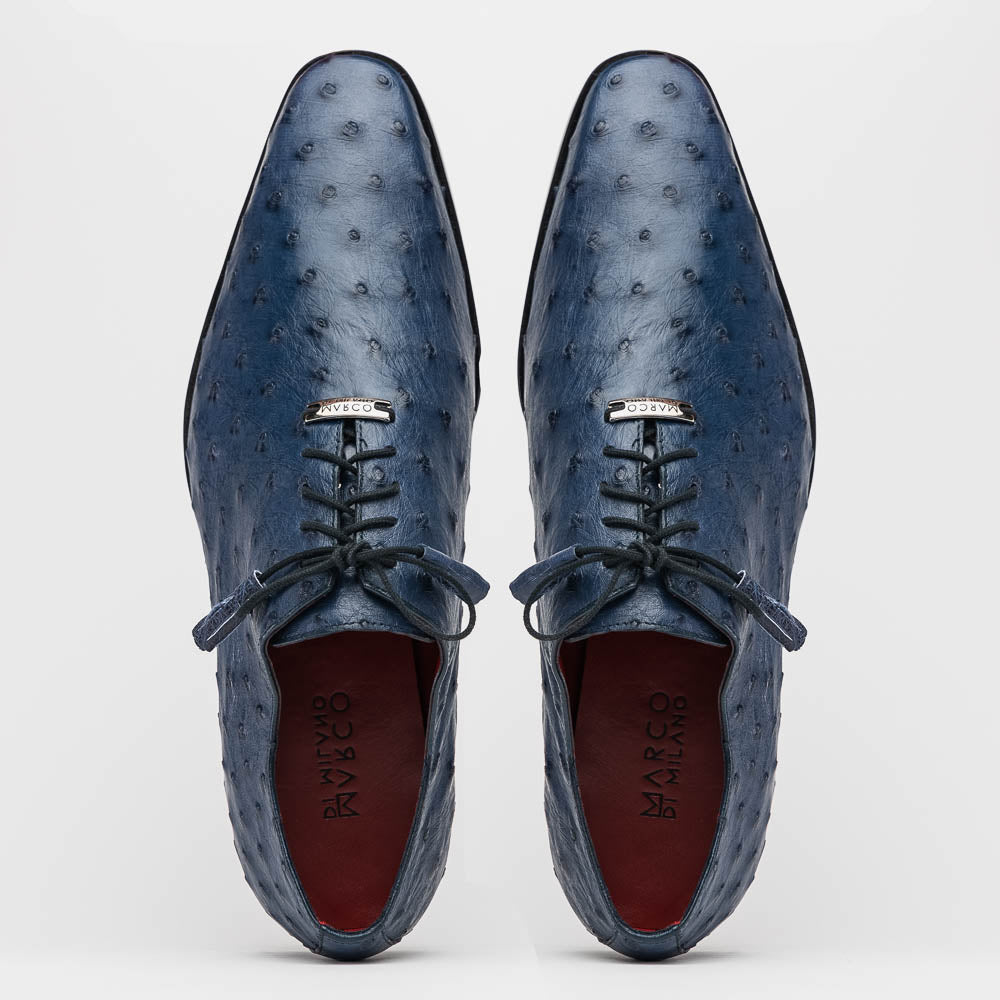 The Criss Navy by Marco Di Milano: a pair of genuine ostrich dress shoes with blue leather, black laces, red inner lining, and brown soles—one upright, one on its side—showcasing luxury men’s footwear.