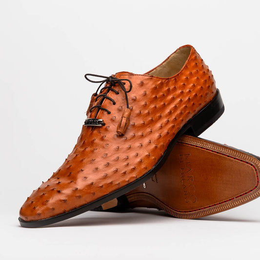 A pair of Criss Brandy genuine ostrich quill leather luxury dress oxfords by Marco Di Milano, with one shoe upright and the other sole up to display the brand name.