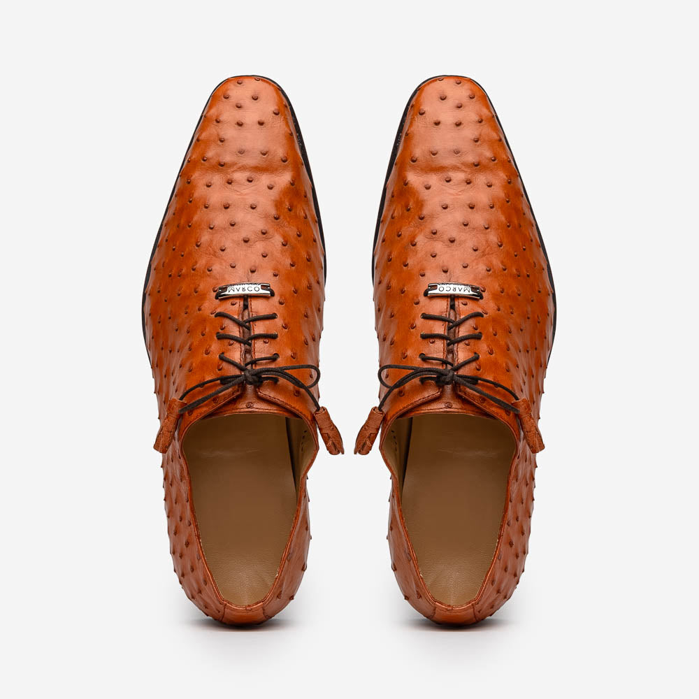 A pair of Criss Brandy genuine ostrich quill leather luxury dress oxfords by Marco Di Milano, with one shoe upright and the other sole up to display the brand name.