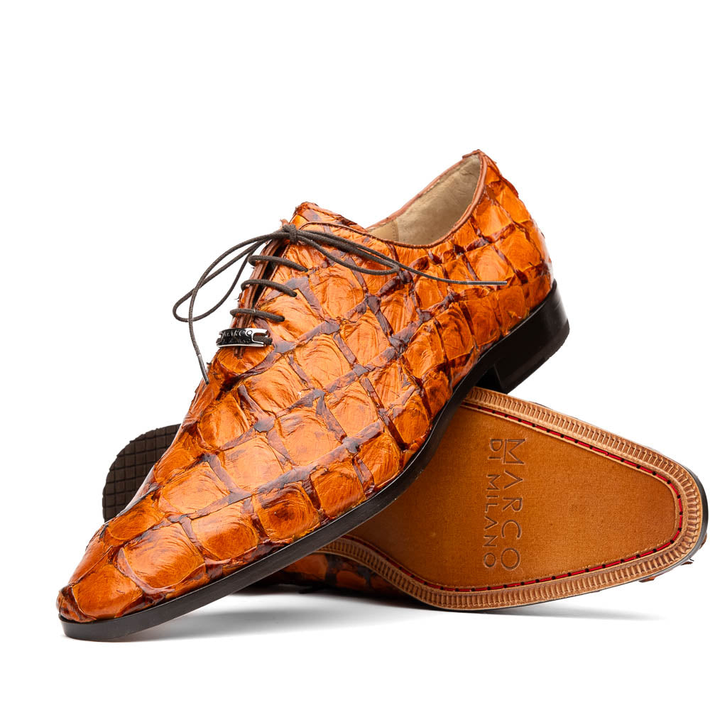 A pair of Olivieri Brandy by Marco Di Milano luxury dress oxford shoes in orange-brown crocodile leather with dark laces, one shoe shown on its side highlighting the branded sole.