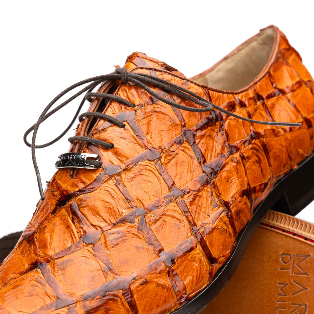 A pair of Olivieri Brandy by Marco Di Milano luxury dress oxford shoes in orange-brown crocodile leather with dark laces, one shoe shown on its side highlighting the branded sole.