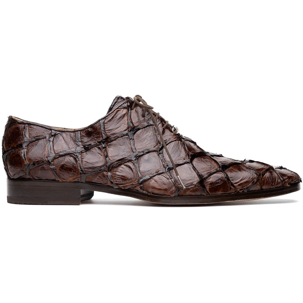 A pair of Olivieri Brown oxford shoes by Marco Di Milano—one upright, one on its side revealing the branded sole—showcase luxurious crocodile leather craftsmanship.