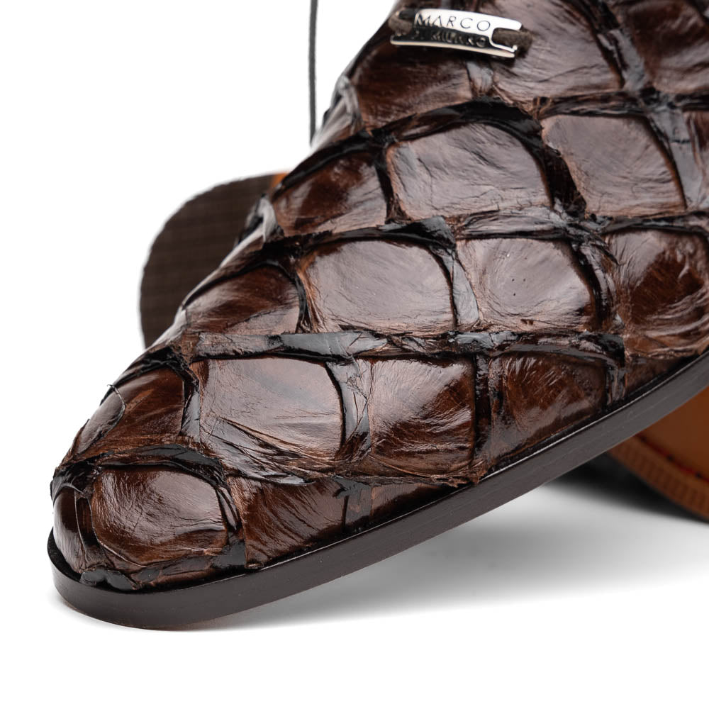 A pair of Olivieri Brown oxford shoes by Marco Di Milano—one upright, one on its side revealing the branded sole—showcase luxurious crocodile leather craftsmanship.