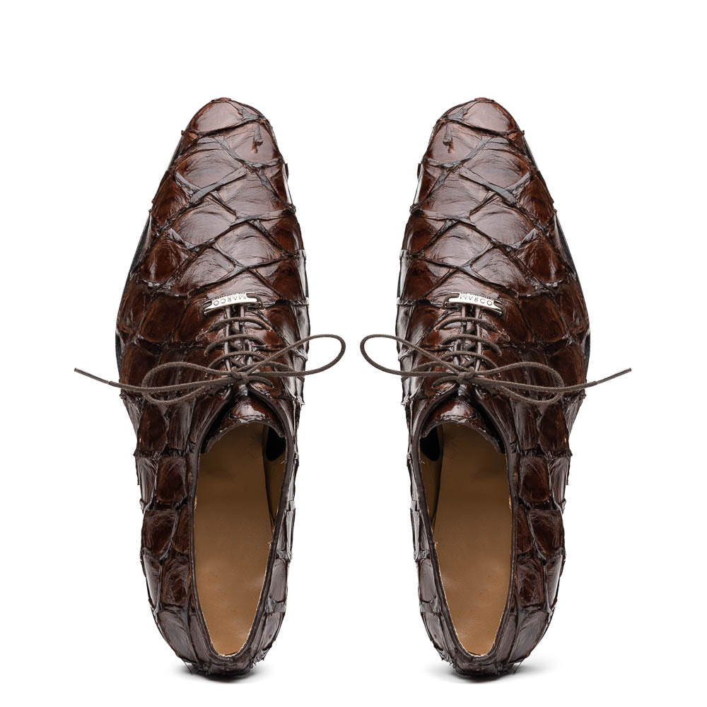 A pair of Olivieri Brown oxford shoes by Marco Di Milano—one upright, one on its side revealing the branded sole—showcase luxurious crocodile leather craftsmanship.
