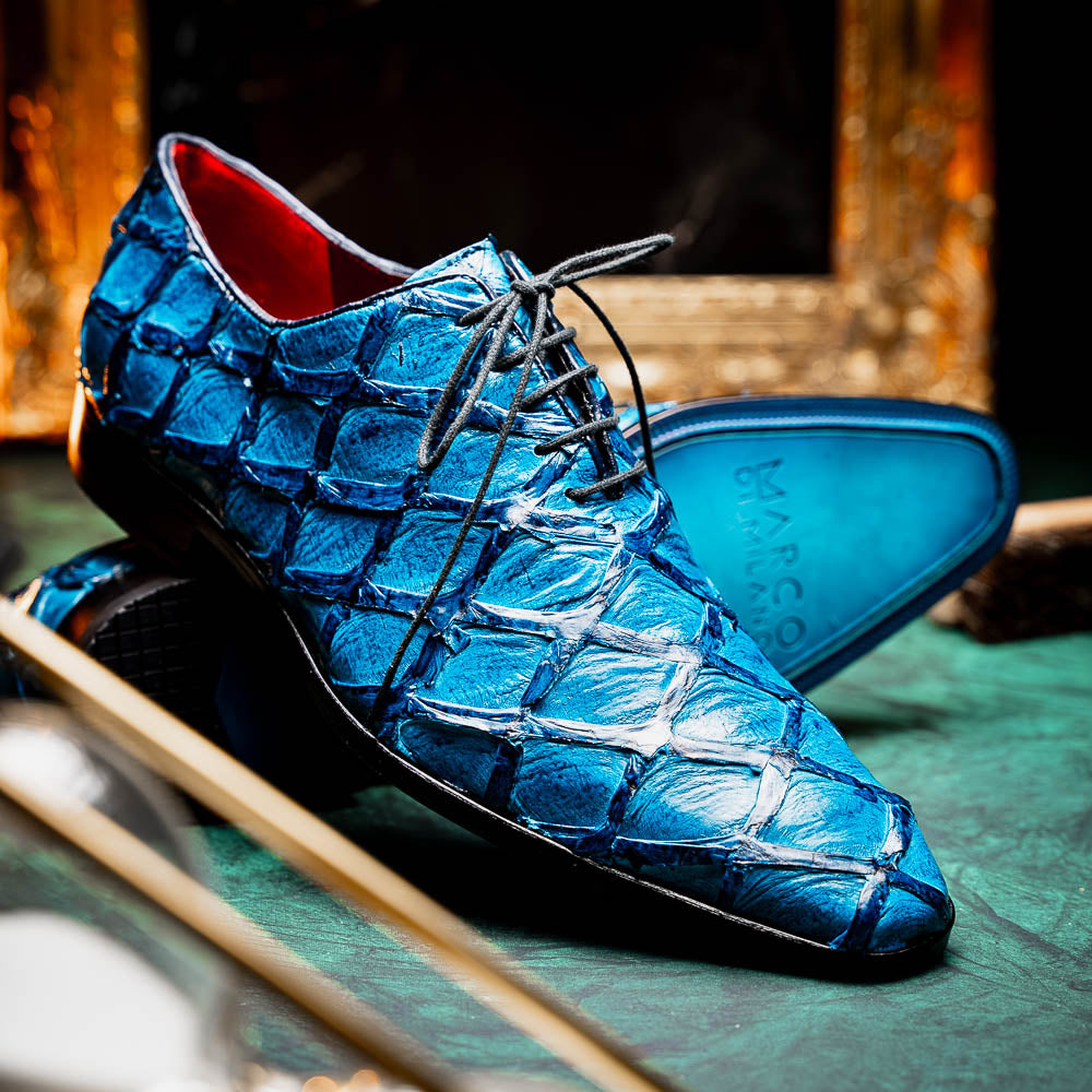 A pair of Marco Di Milano Olivieri Caribbean Blue crocodile leather oxfords with red interior lining; one shoe stands upright, the other shows its sole with "Marco Di Milano" branding.