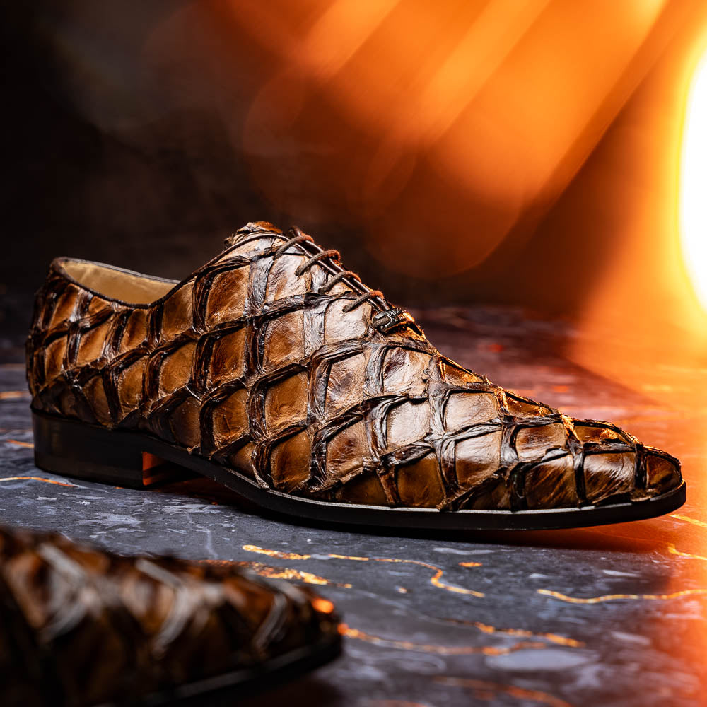 The Olivieri Clear Brown oxford shoes by Marco Di Milano showcase a textured crocodile leather design; one shoe stands upright as the other lies on its side, displaying the sole.