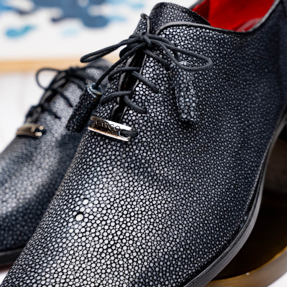 A pair of black textured Pannuci Black oxfords by Marco Di Milano, featuring red inner lining and a tan sole with the brand's logo—luxury footwear for those who value timeless style.