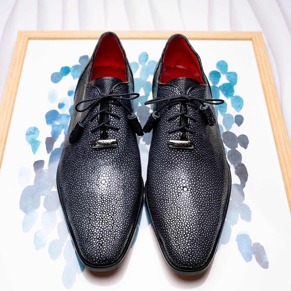 A pair of black textured Pannuci Black oxfords by Marco Di Milano, featuring red inner lining and a tan sole with the brand's logo—luxury footwear for those who value timeless style.