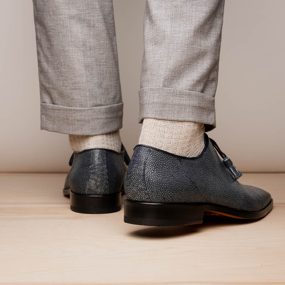 A pair of black textured Pannuci Black oxfords by Marco Di Milano, featuring red inner lining and a tan sole with the brand's logo—luxury footwear for those who value timeless style.
