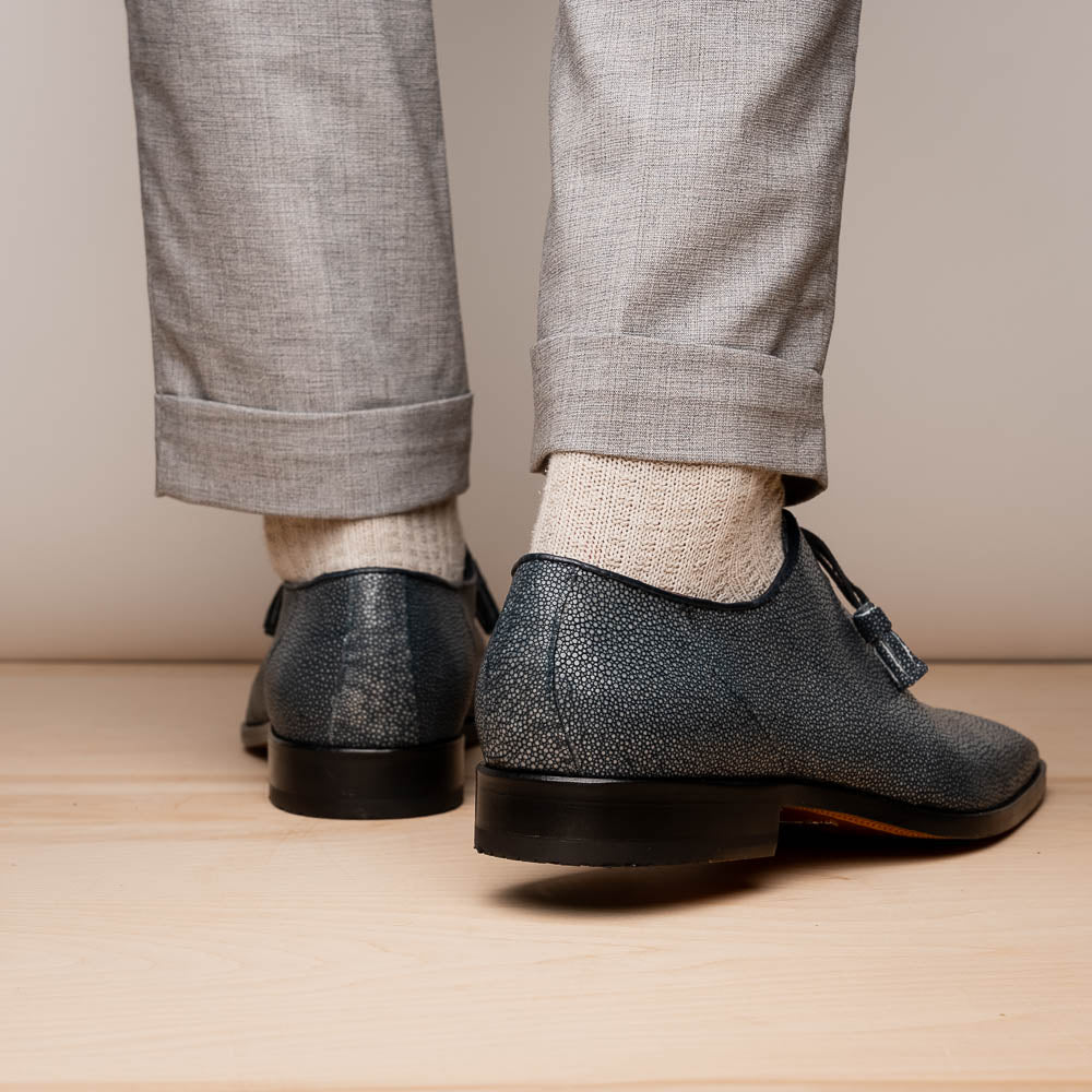 A pair of Marco Di Milano Pannuci Navy dress oxford shoes in textured dark blue leather with black laces, red inner lining, and tan soles—one displayed on its side to showcase the branded sole.