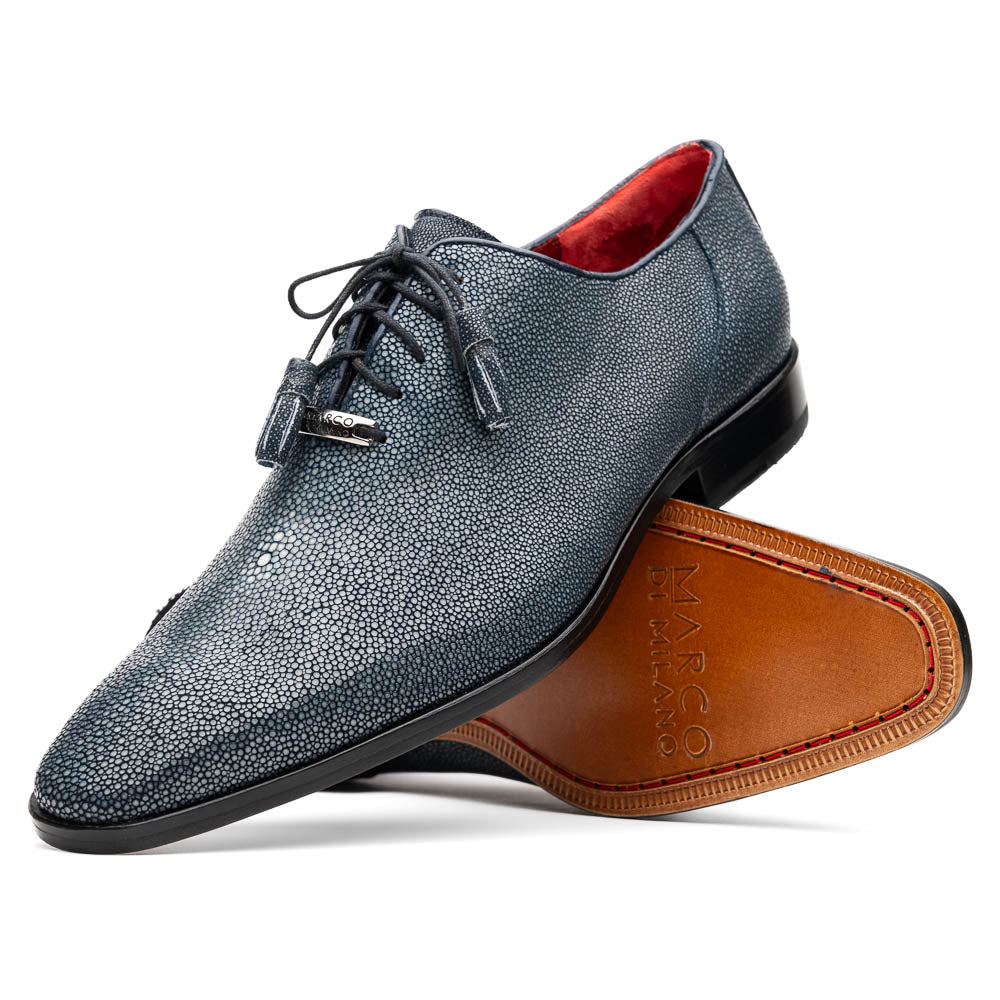 A pair of Marco Di Milano Pannuci Navy dress oxford shoes in textured dark blue leather with black laces, red inner lining, and tan soles—one displayed on its side to showcase the branded sole.