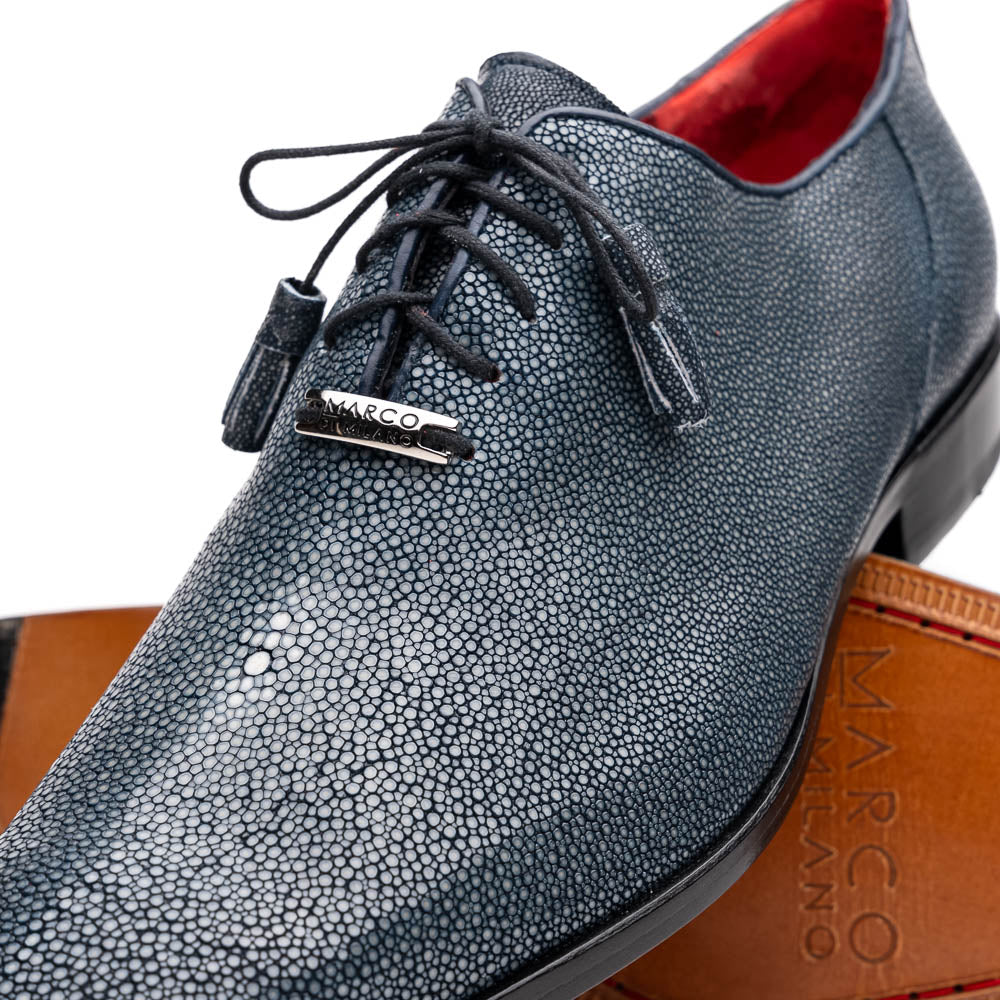 A pair of Marco Di Milano Pannuci Navy dress oxford shoes in textured dark blue leather with black laces, red inner lining, and tan soles—one displayed on its side to showcase the branded sole.