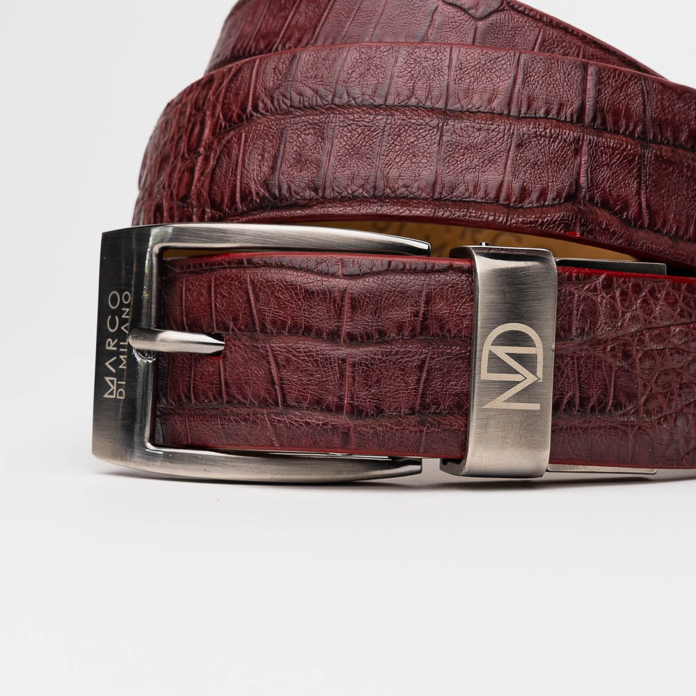 Experience the luxury of Marco Di Milano’s renowned collection of exotic leather belts with the Silvio Belt Wine—a maroon caiman fuscus-back leather belt featuring a crocodile pattern and finished with a silver buckle engraved with the “Marco Di Milano” branding and “MD” logo.