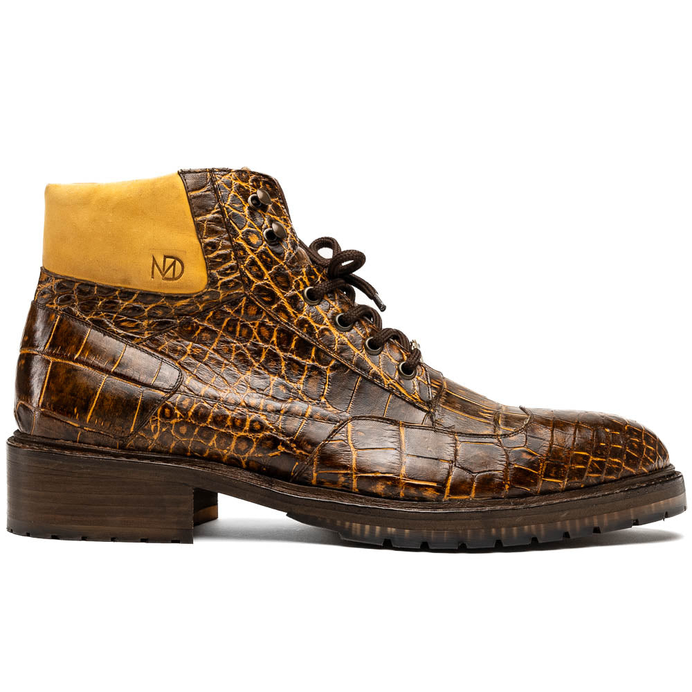 The Potenza Mustard/Brown boots by Marco Di Milano feature brown crocodile-pattern leather, lace-up fronts, tan ankle detail, and textured rubber soles with hand-painted finishes—one boot upright, the other on its side.