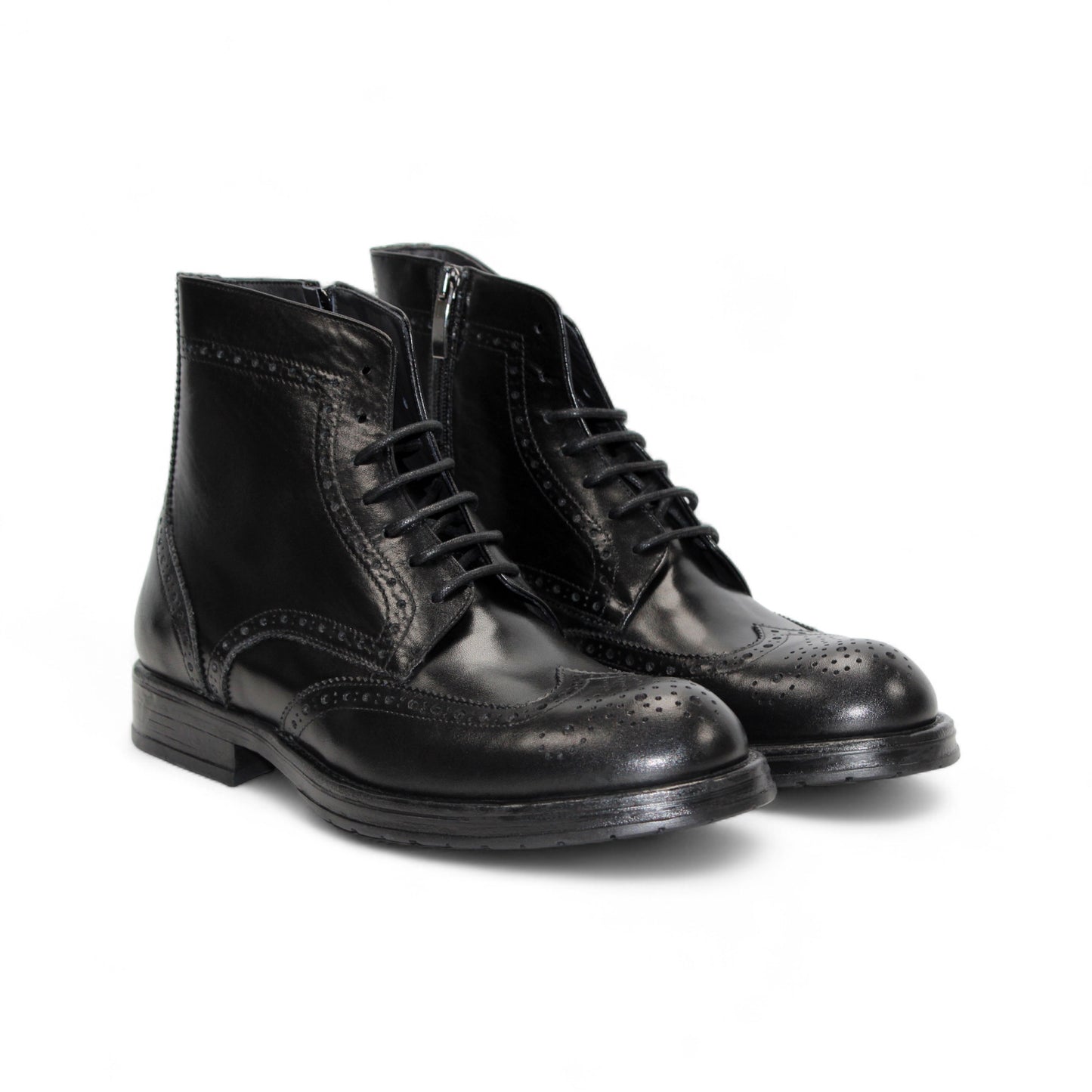 The Firmani Daniel Black ankle boot by Firmani features black genuine leather, brogue detailing, and lace-up closure, shown in a side profile against a white background.
