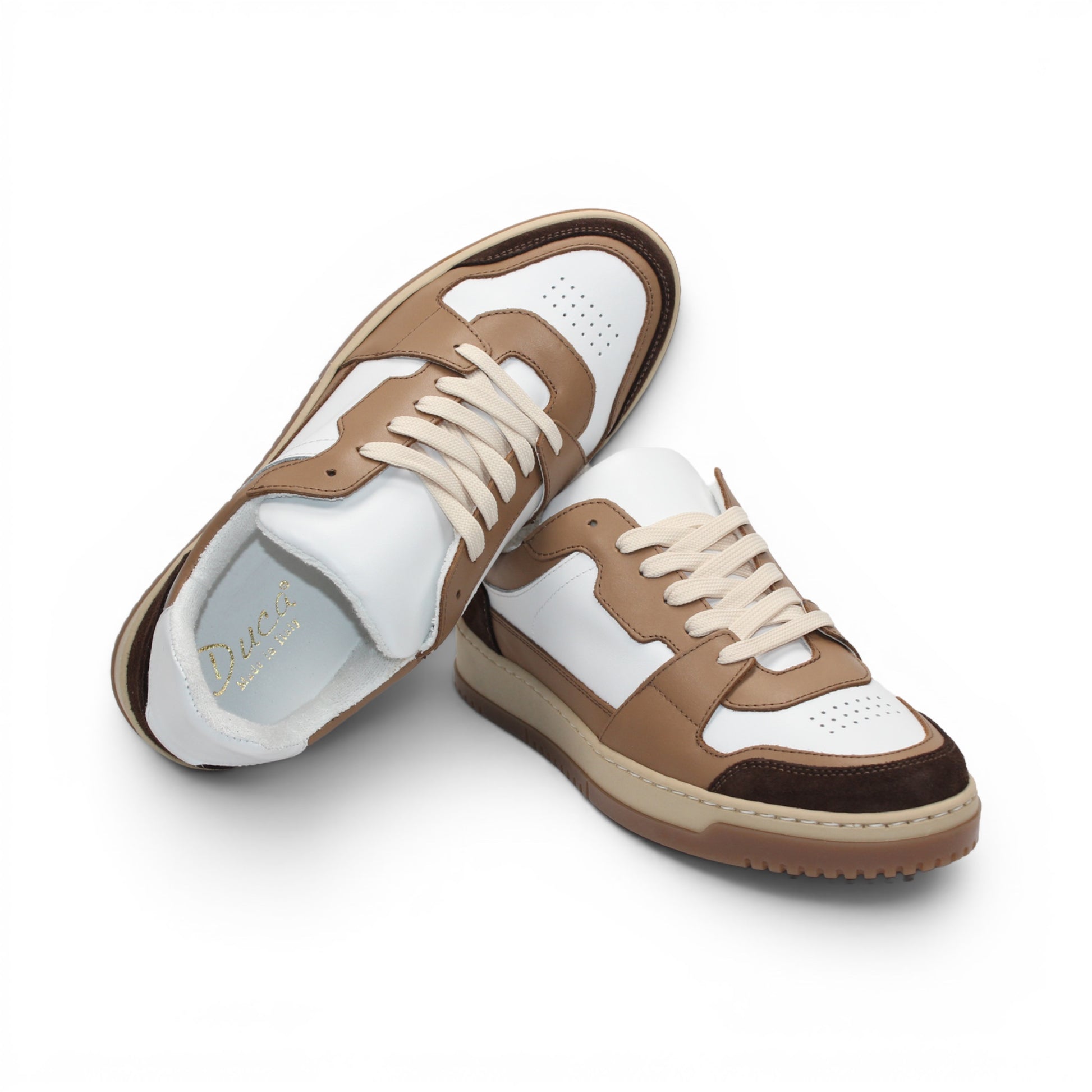 The Duca Di Matiste Duca DC80 Brown Combo is a low-top sneaker featuring a white upper, brown and tan overlays, beige laces, and a light brown sole, crafted from premium calf leather for casual elegance.
