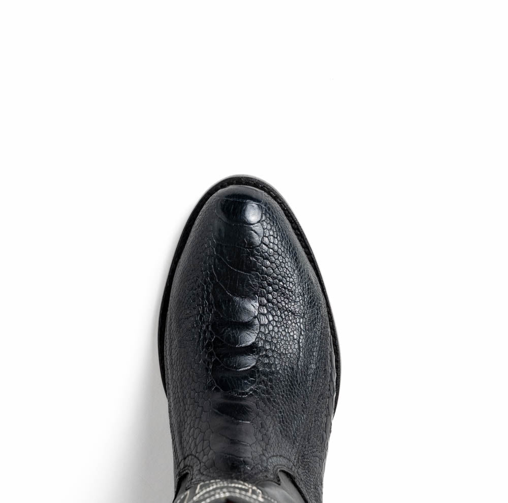 A pair of Denver Black cowboy boots by Marco Di Milano in genuine black ostrich leather, one upright and one displaying the sole with white stitching and the Marco Di Milano logo.
