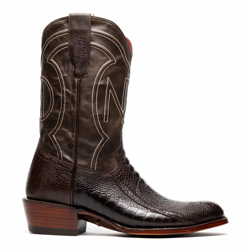 A pair of Denver Brown Western boots by Marco Di Milano in dark brown textured leather, featuring contrast stitching and genuine ostrich style; one boot shows the branded sole.