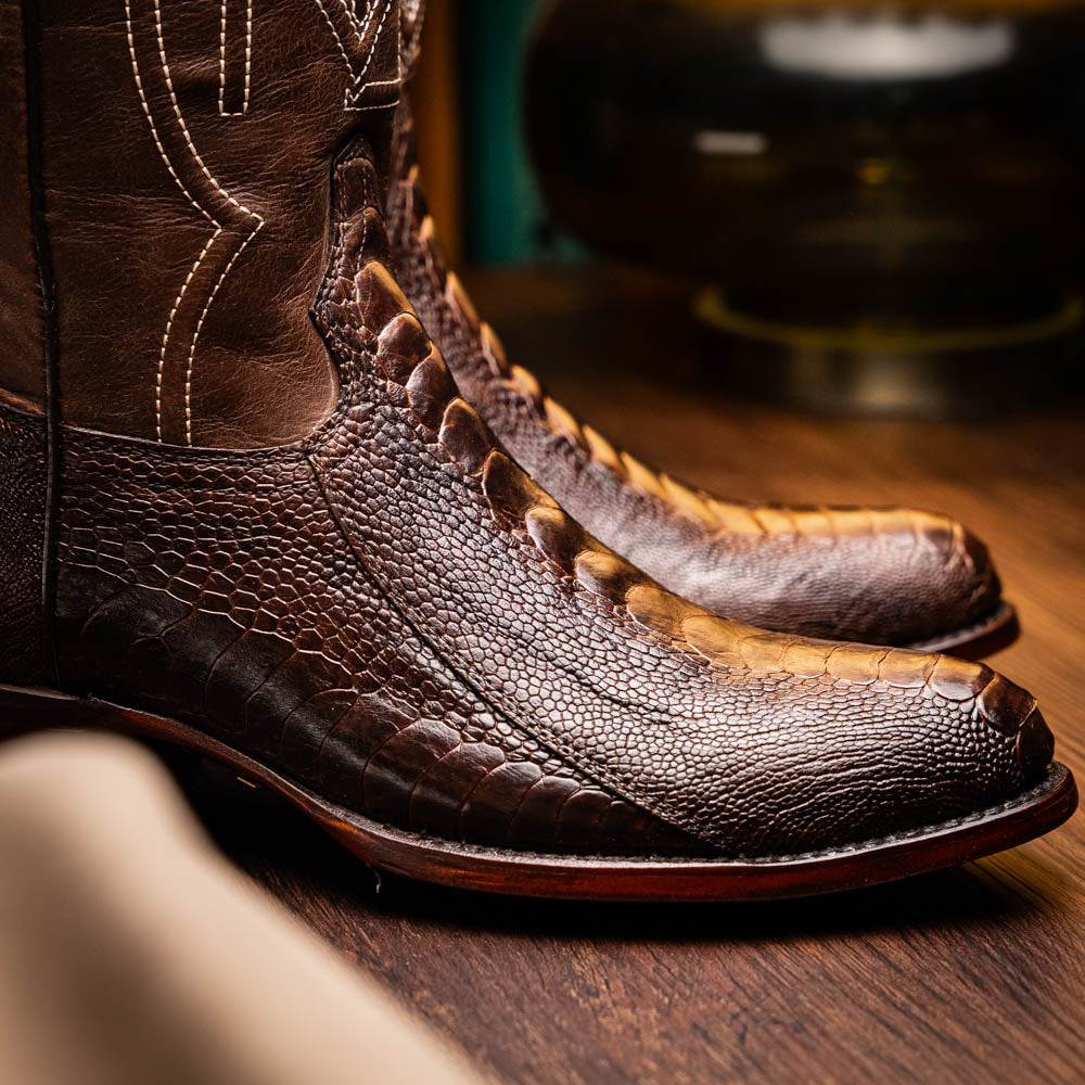 The Denver Clear Brown by Marco Di Milano are textured leather Western cowboy boots in brown, featuring white stitching and branded soles.