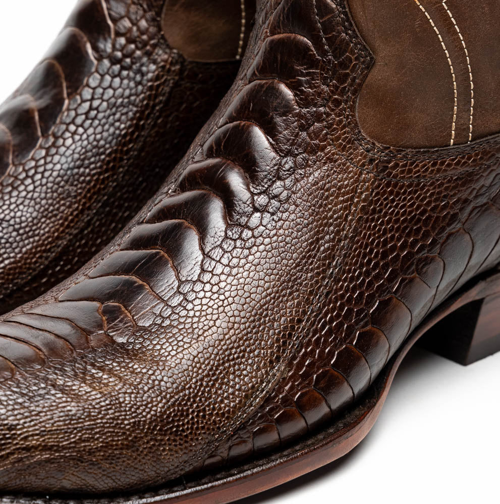 The Denver Clear Brown by Marco Di Milano are textured leather Western cowboy boots in brown, featuring white stitching and branded soles.