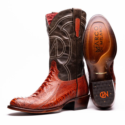 The Denver Rustic Cognac by Marco Di Milano is a pair of Western cowboy boots with brown leather vamps, dark shafts, decorative stitching, and the brand name on the sole.