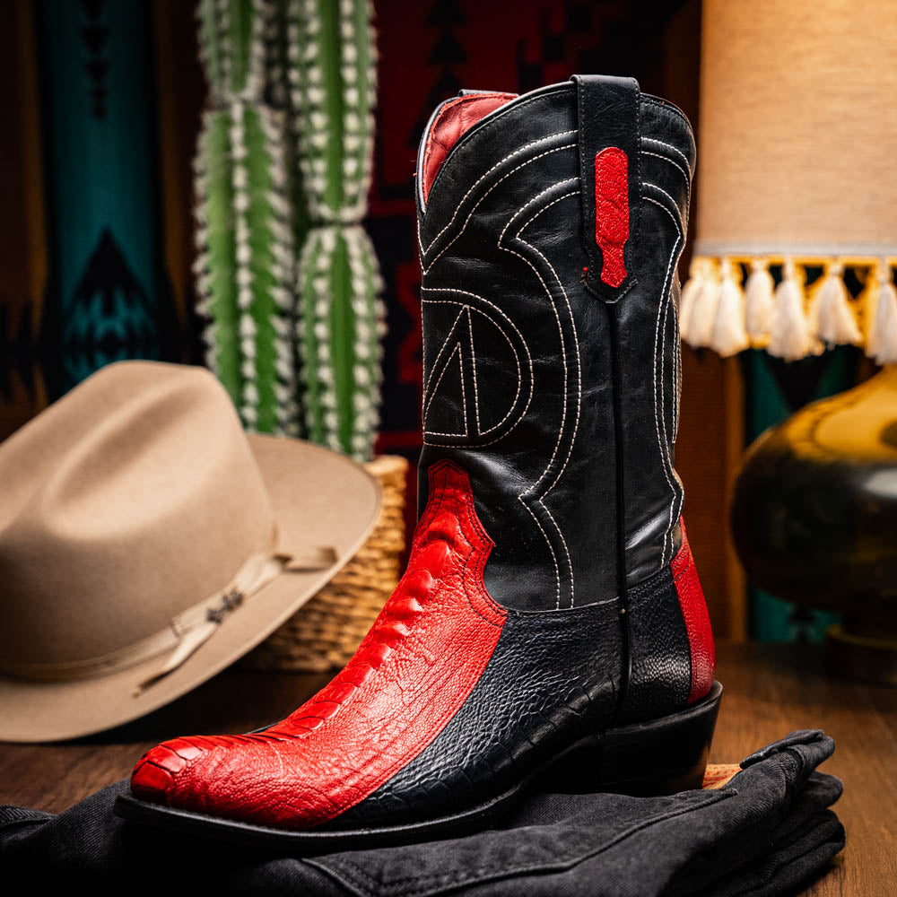 The Marco Di Milano Denver Red / Black boots feature red and black leather, a textured pattern, decorative stitching, and a branded sole—one boot stands upright while the other displays the sole.