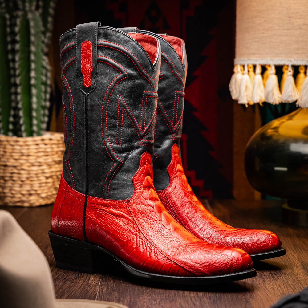 The Denver Red boots by Marco Di Milano feature bold red and black genuine ostrich skin—one boot upright, one showing the sole with the signature logo—for a striking, luxurious Western style.