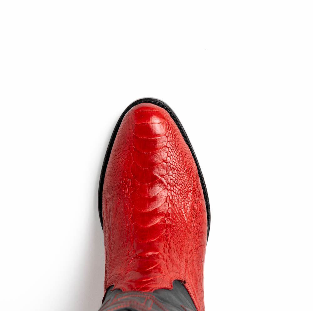 The Denver Red boots by Marco Di Milano feature bold red and black genuine ostrich skin—one boot upright, one showing the sole with the signature logo—for a striking, luxurious Western style.