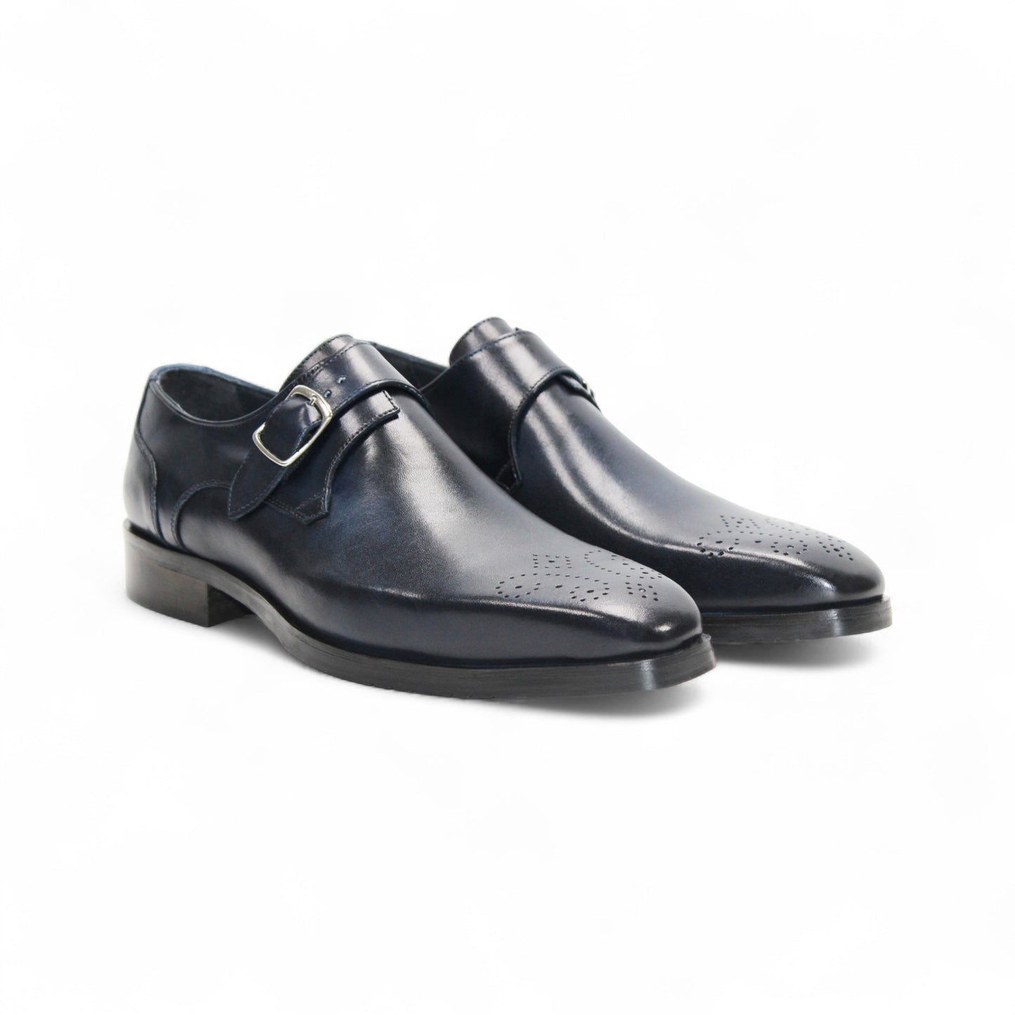 The Firmani Duncan Navy by Firmani is a navy genuine leather monk strap dress shoe with a silver buckle, low heel, and perforated toe detailing, displayed against a white background.