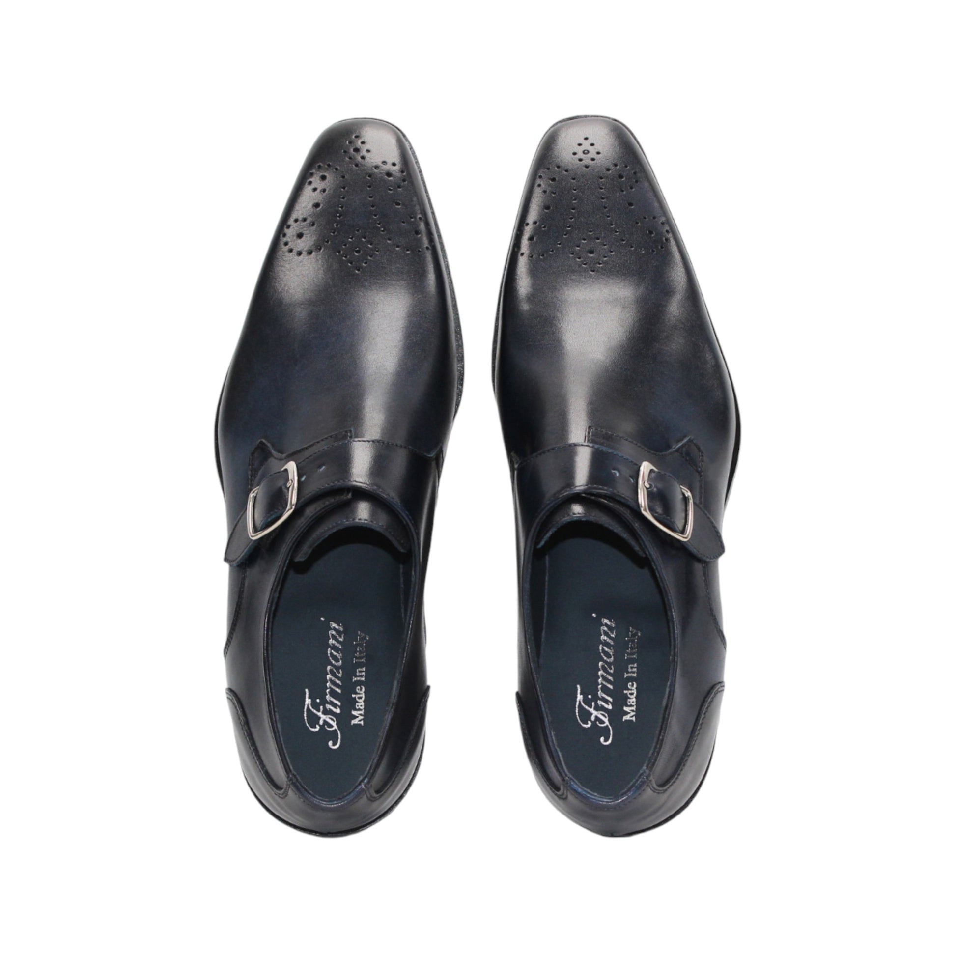 The Firmani Duncan Navy by Firmani is a navy genuine leather monk strap dress shoe with a silver buckle, low heel, and perforated toe detailing, displayed against a white background.