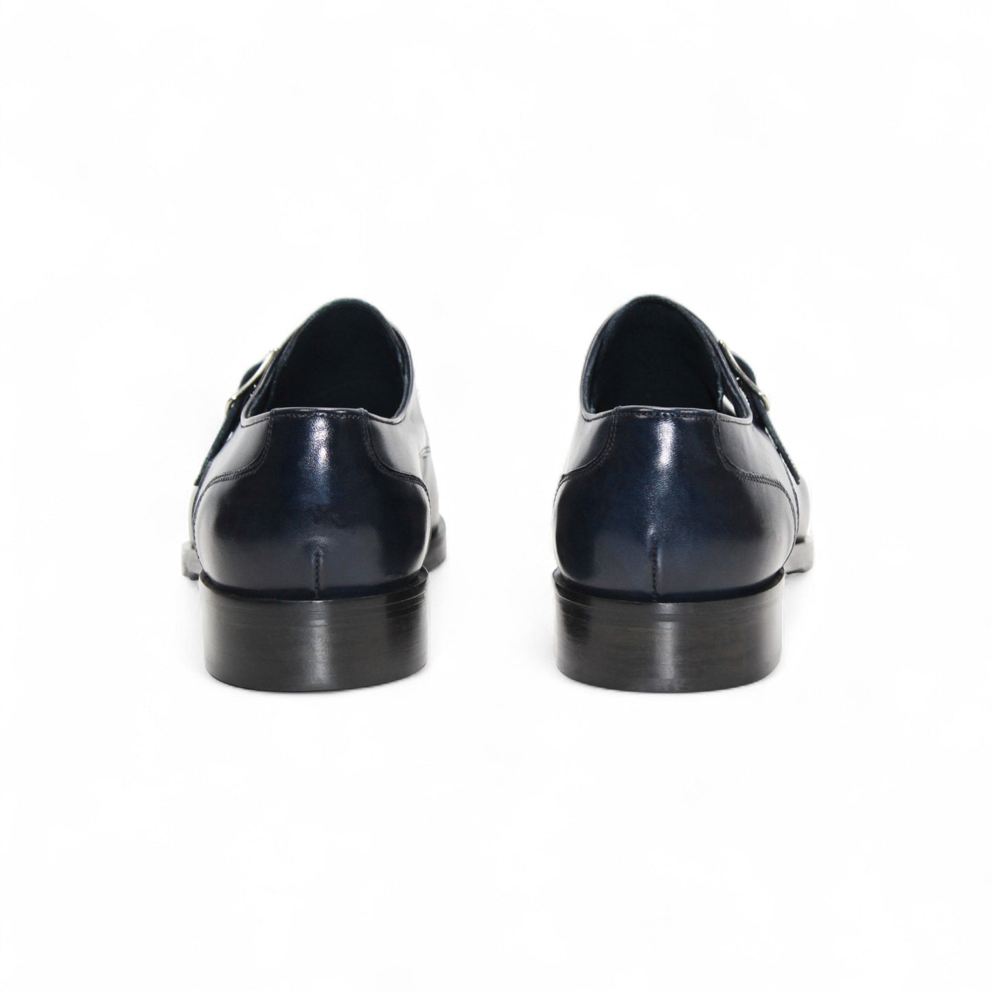 The Firmani Duncan Navy by Firmani is a navy genuine leather monk strap dress shoe with a silver buckle, low heel, and perforated toe detailing, displayed against a white background.