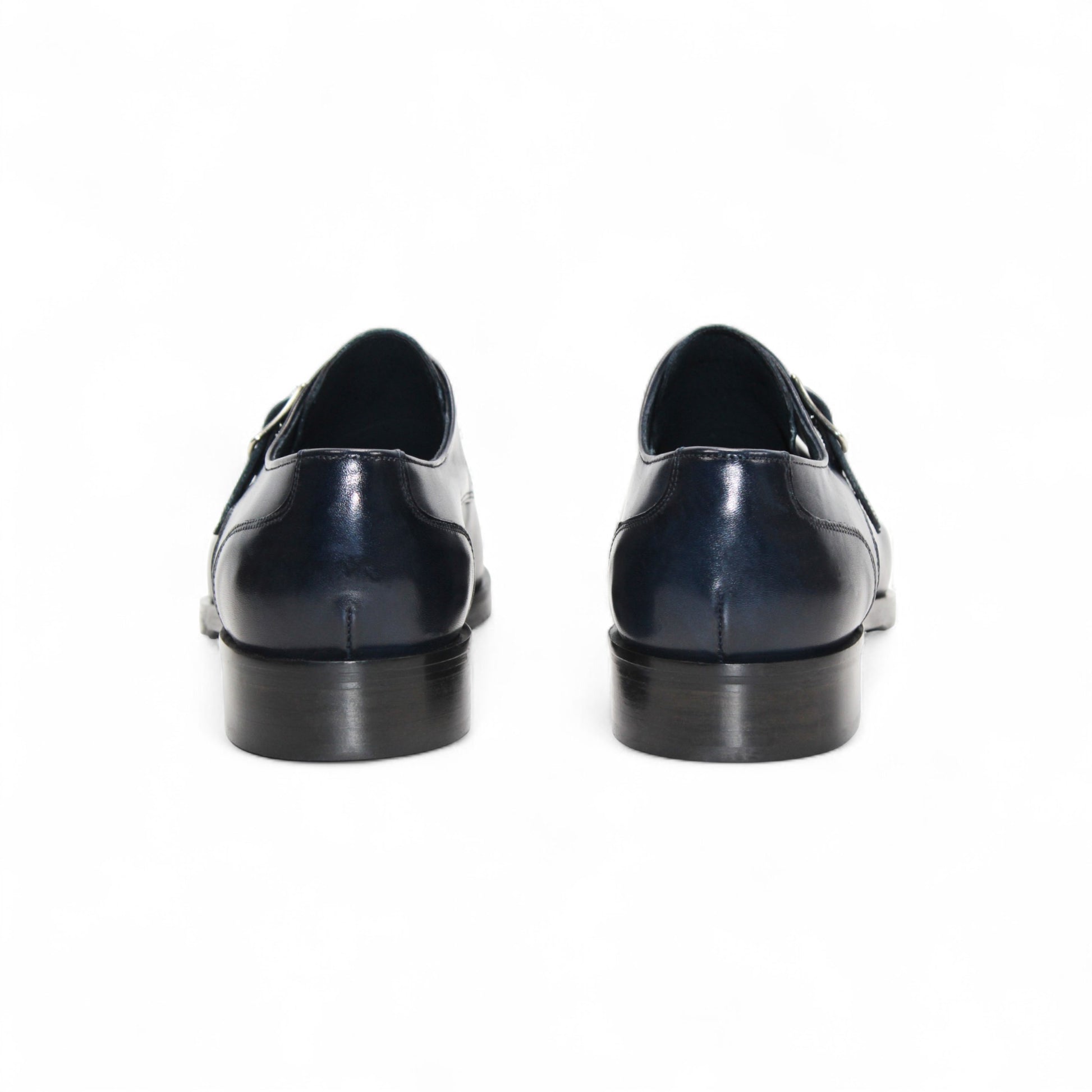 The Firmani Duncan Navy by Firmani is a navy genuine leather monk strap dress shoe with a silver buckle, low heel, and perforated toe detailing, displayed against a white background.