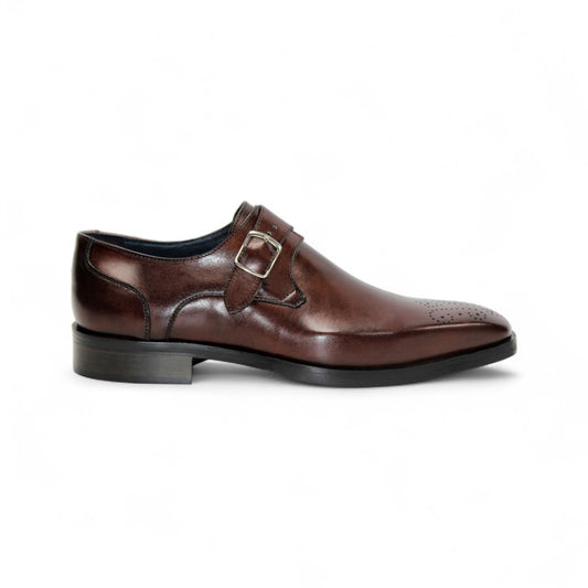 The Firmani Duncan Chocolate men's dress shoe features brown Italian leather, a silver buckle, and perforated detailing, displayed in side profile on a white background.