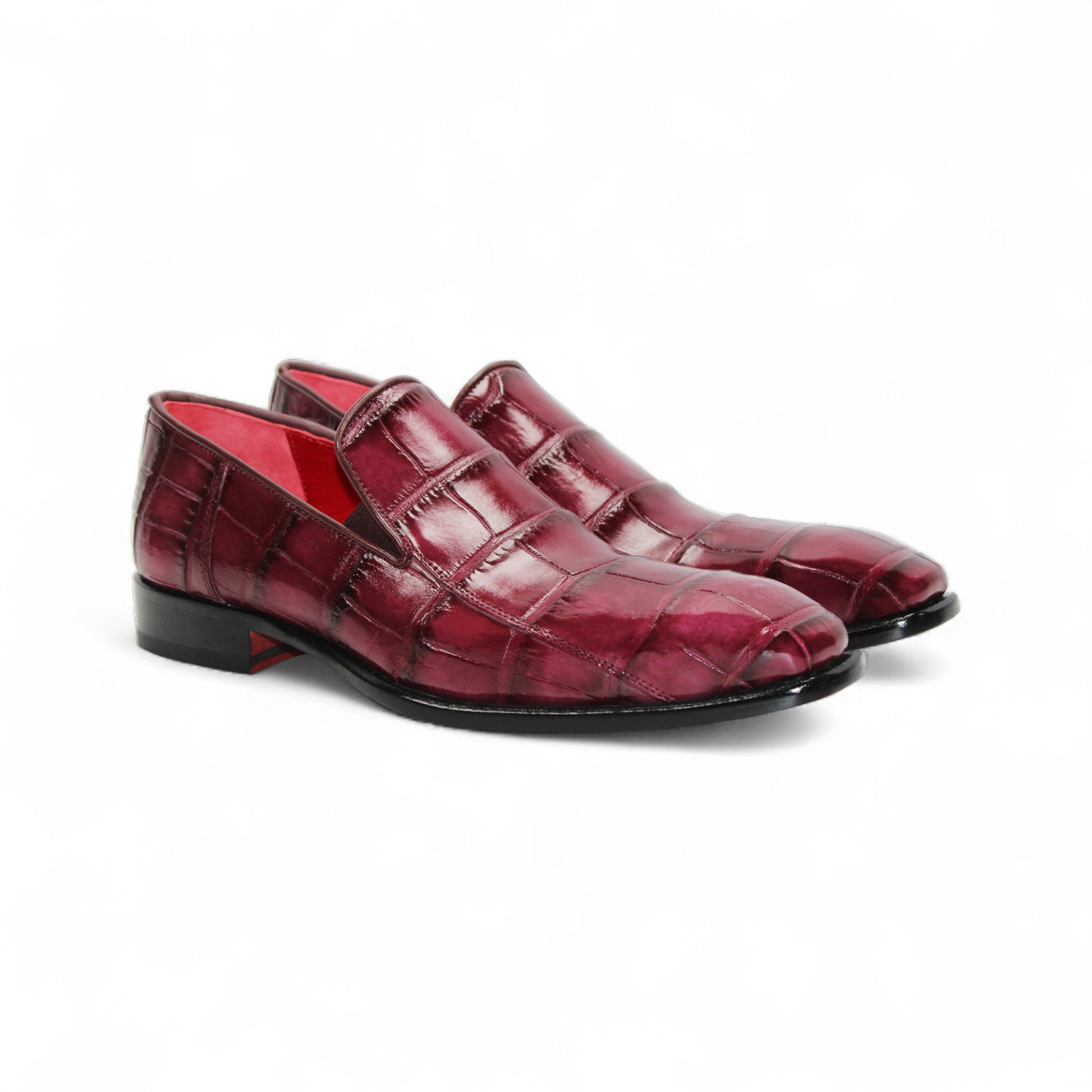 The Fennix Dustin Bordo by Fennix of Italy is a single burgundy loafer in genuine alligator leather with a crocodile pattern, leather sole, and low black heel, displayed on a white background.