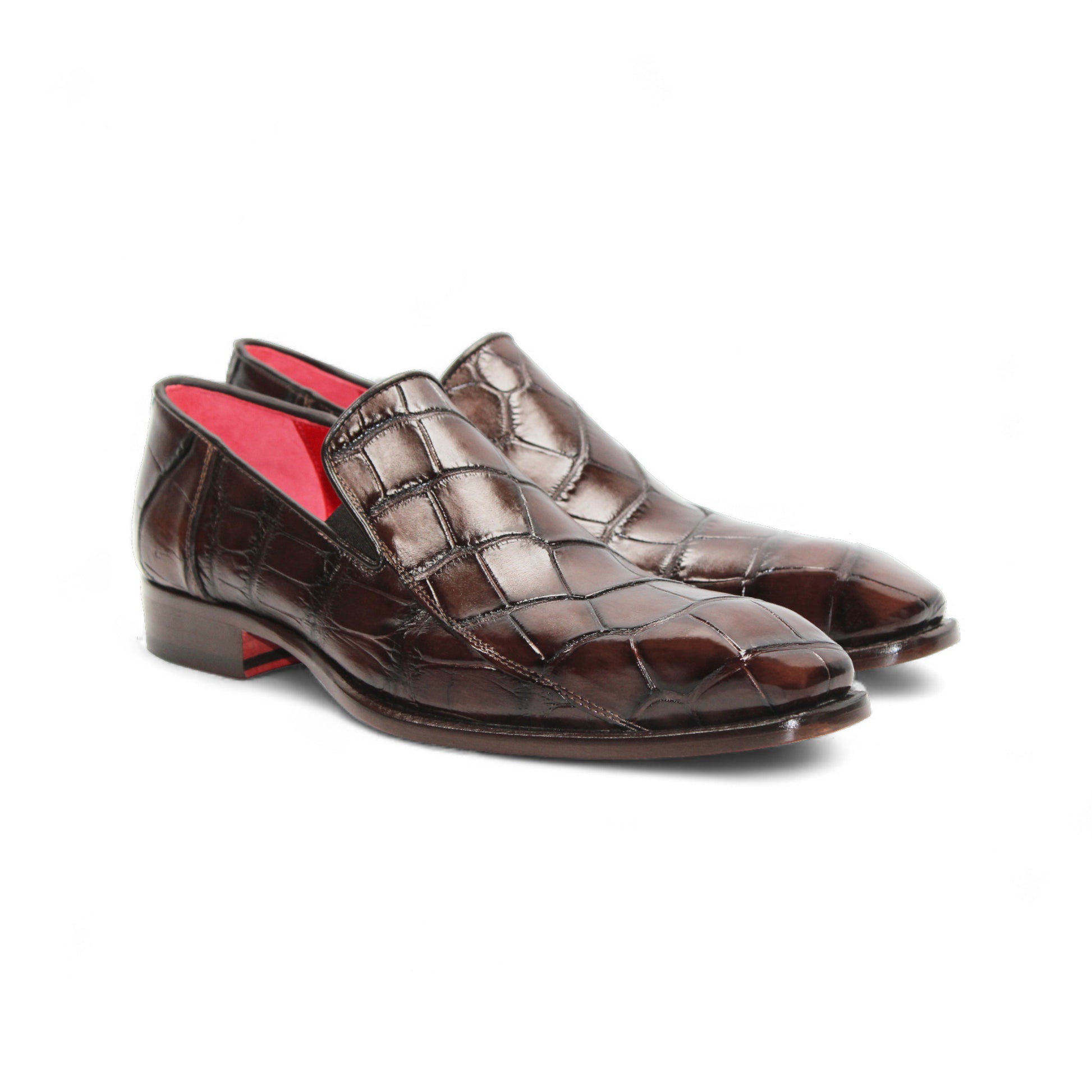 The Fennix Dustin Brown loafer by Fennix of Italy features premium brown leather, Italian craftsmanship, a textured pattern, low heel, and red interior lining, showcased in a side profile against a white background.